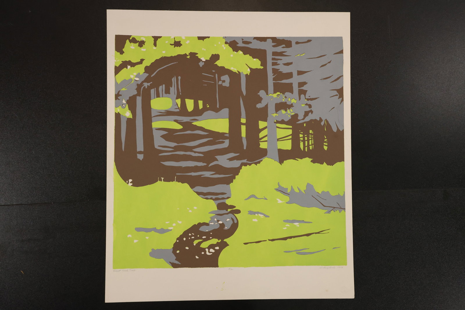 R. Angeloch Signed Green Woodland Color Print: A signed color print by R. Angeloch depicting a winding stream through a wooded landscape. Bright yellow-green areas contrast with brown trunks and muted gray foliage. Size: 22.5 x 19 inches. Shelf ID