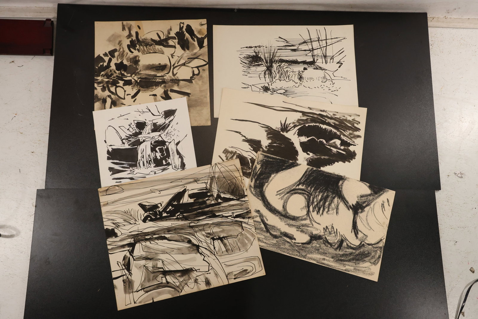 R. Angeloch Group of Expressive Black and White Drawings: A group of drawings on paper by R. Angeloch, featuring bold black strokes, angular landscapes, and abstract natural forms. Includes the complete group shown in the photographs. Size: 14 x 17 inches. S