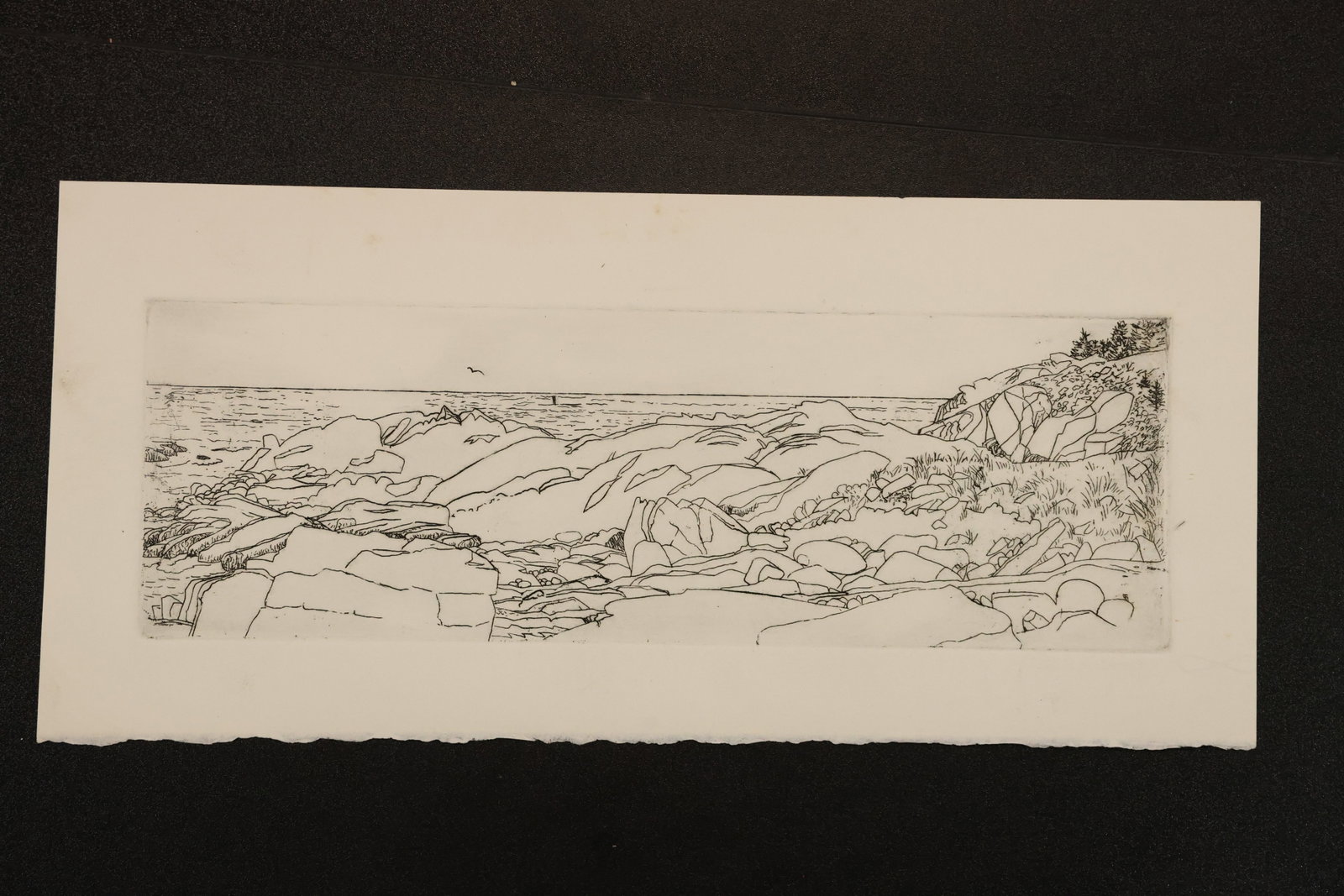 R. Angeloch Rocky Coast Line Drawing: A horizontal line drawing by R. Angeloch depicting a rugged coast with layered rock formations and an open stretch of water. Delicate outlines emphasize the contours of the shoreline. Size: 6.5 x 14 i