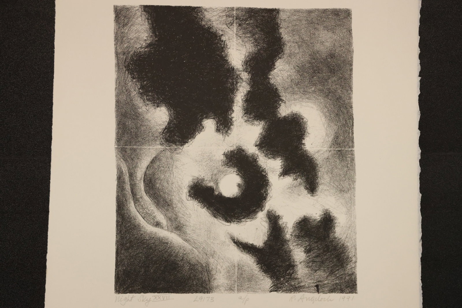 R. Angeloch Swirling Clouds and Moon Black and White Print: A black and white print by R. Angeloch featuring a pale circular moon within sweeping dark cloud formations. The vertical composition uses soft shading and contrasting light areas. Size: 13 x 17 inche