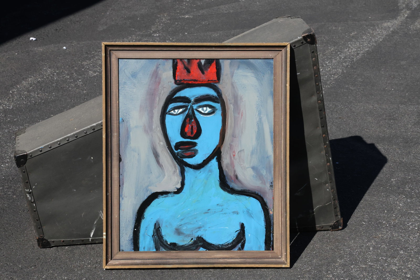 Thomas Pulgini Blue Figure with Red Crown Painting: Painting by Thomas Pulgini. A blue bust with large eyes, dark contours, and a tall red crown stands against a softly brushed gray-blue background. A small red facial accent echoes the color of the cro