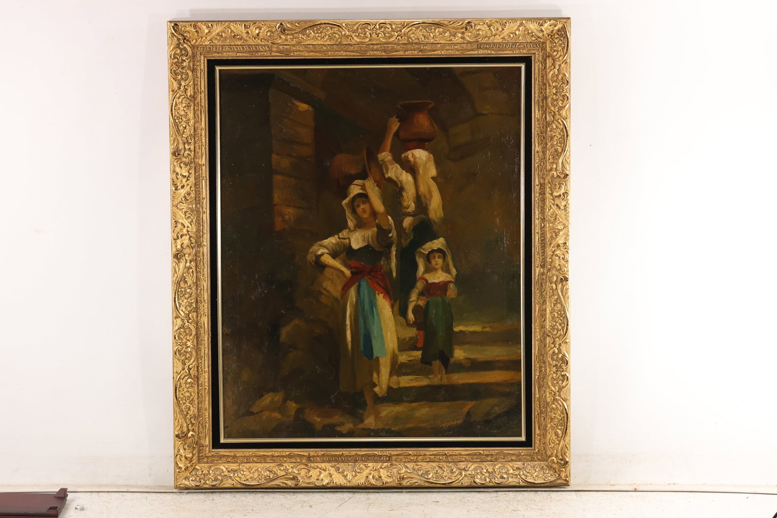 Women and Child on Stone Steps Oil Painting: Oil painting on canvas depicting women and a child on stone steps beside a dark building, including a figure carrying a pottery vessel overhead. Warm brown shadows contrast with white blouses, colorfu