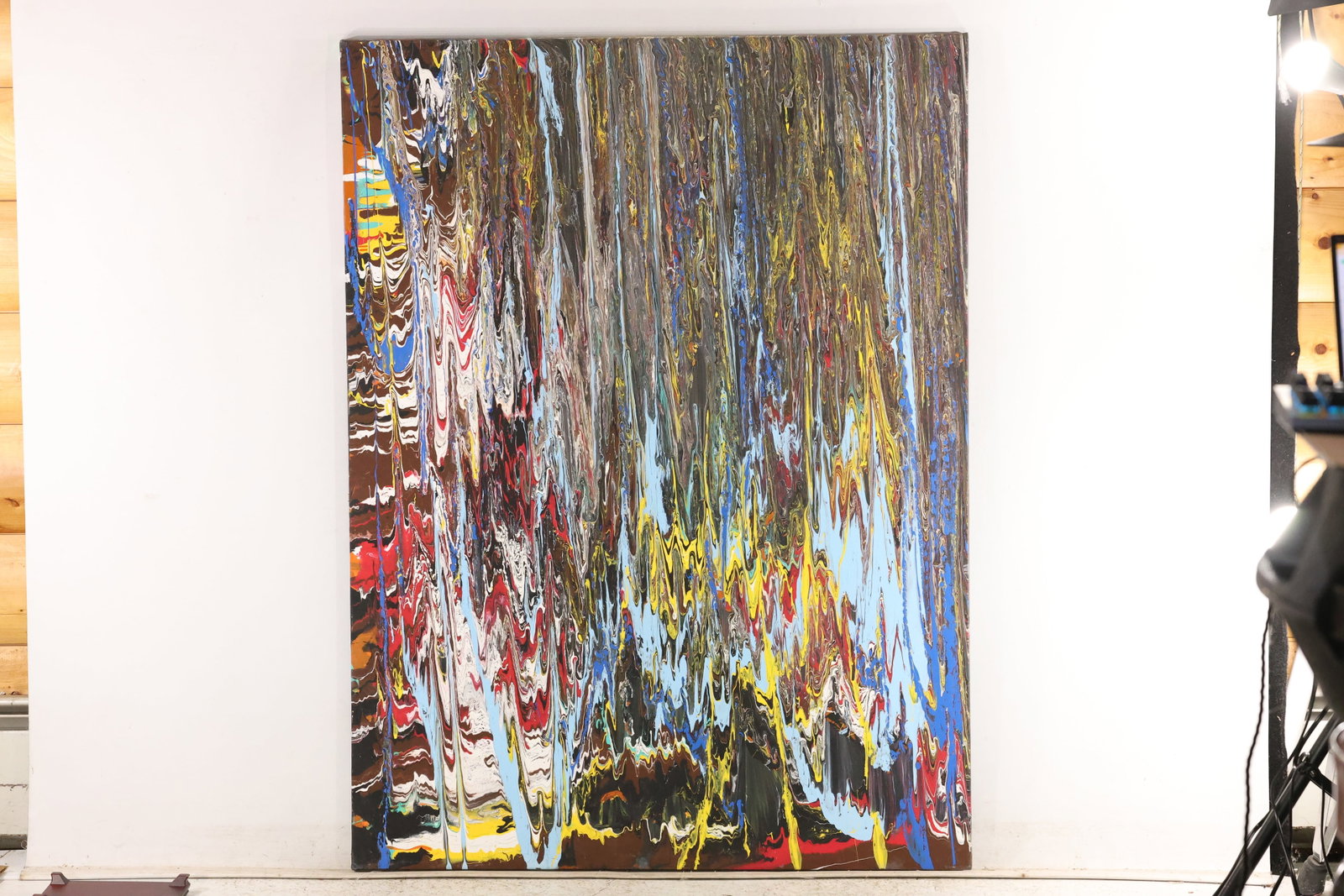 Large Multicolor Drip Abstract Painting on Canvas: Large vertical painting on canvas composed of closely spaced paint trails in white, yellow, red, blue, and gray over a dark ground. Long vertical streaks open into looping and pointed forms near the