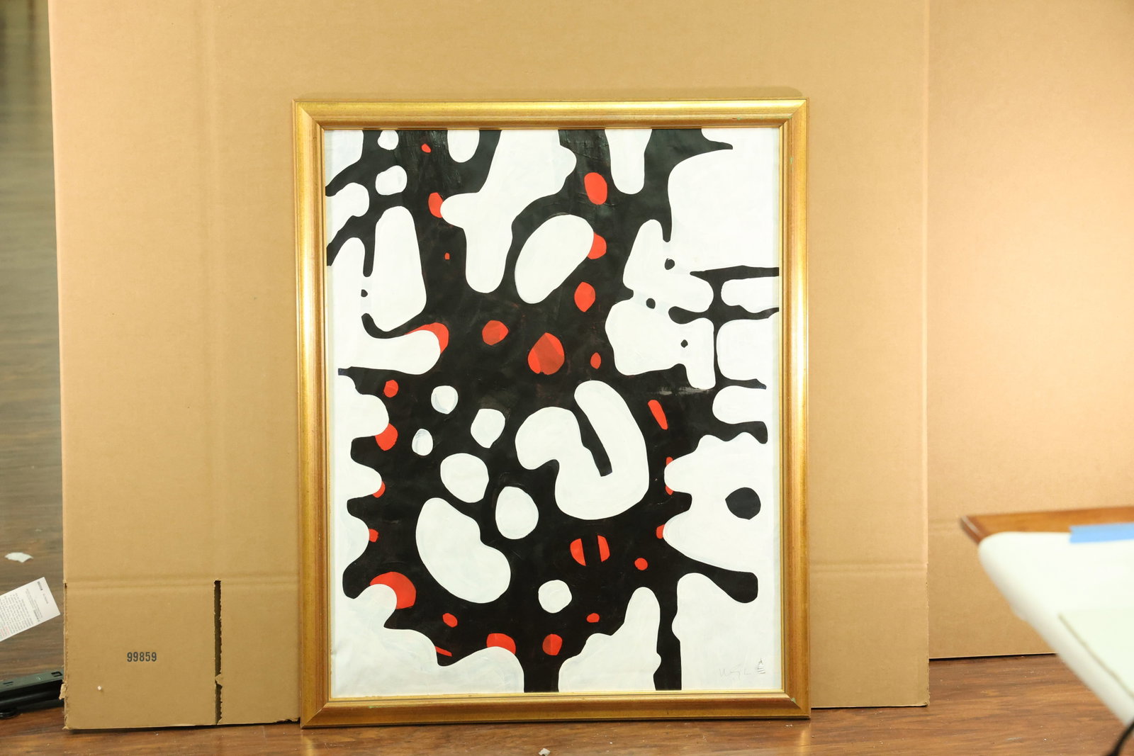Black and Red Abstract Artwork Labeled Wayne Cunningham: Vertical abstract artwork with branching black forms, rounded white openings and small red accents. A reverse inscription reads ARTIST WAYNE CUNNINGHAM and ACRYLIC ON PAPER. Presented in a narrow gold