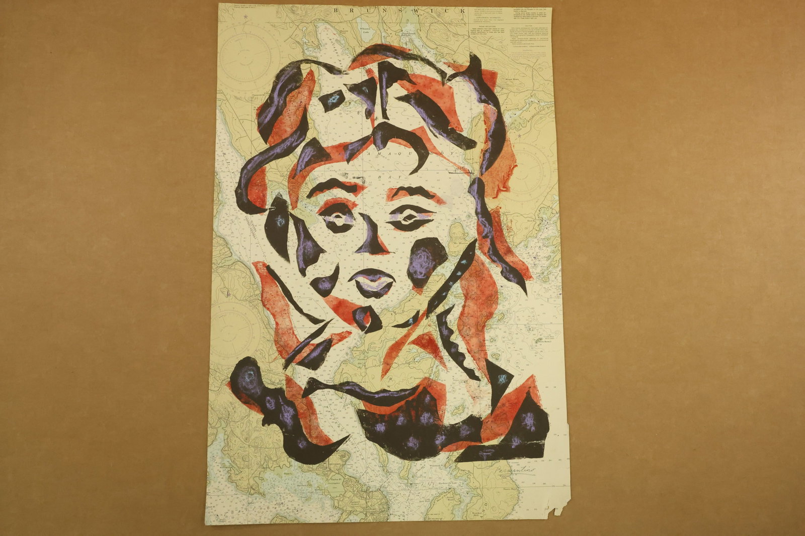 Abstract Face on Printed Map Signed Passuntino: Work on a printed map depicting a large stylized face formed from black, red and purple shapes. Geographic lines and printed place names remain visible through the open areas. Signed Passuntino at the
