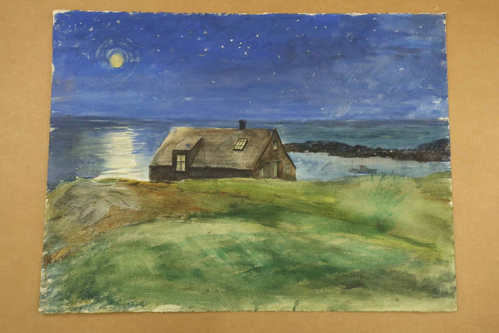 Moonlit Coastal Cottage Watercolor Attributed to Franklin Shores: Watercolor on paper depicting a small dark cottage beside the sea under a blue star filled sky. A yellow moon casts a pale reflection across the water, with green sloping ground in front. Unsigned in 