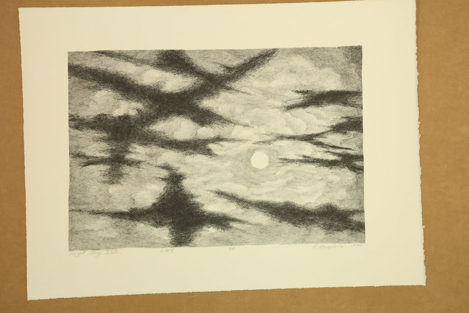 Night Sky XXIX Print Signed R Angeloch 1994 Numbered 6/8: Monochrome print on paper depicting a circular moon behind intersecting dark cloud bands. Grainy black and gray passages surround lighter openings. Titled Night Sky XXIX, signed R Angeloch, dated 1994