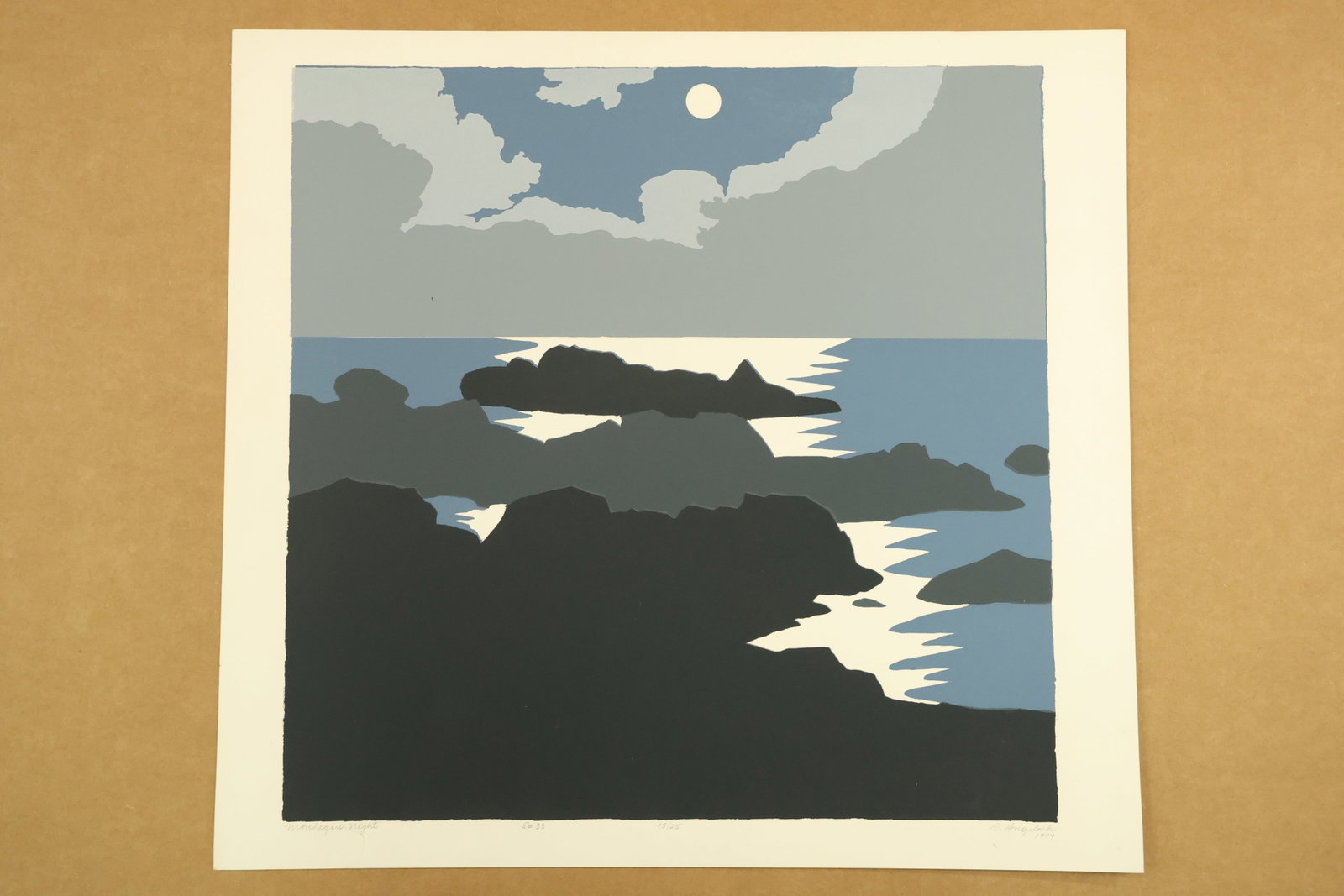 Monhegan Night Color Print Signed R Angeloch 1979 Numbered 15/25: Color print on paper showing dark rocky headlands, blue water and angular white reflections beneath a circular moon and gray clouds. The lower margin is titled Monhegan Night, signed R Angeloch, dated