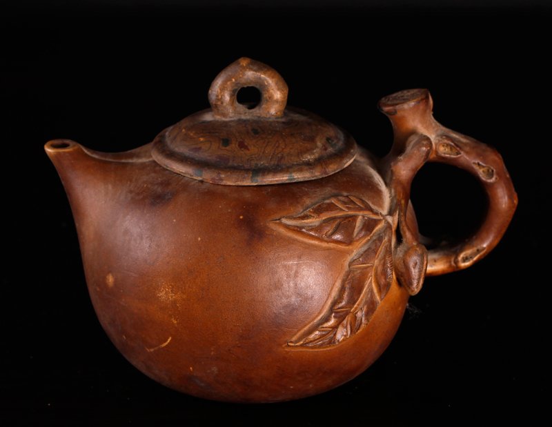 Chinese Zisha Clay Teapot: With branch handle, extending to body depicting leaves and berries. 4" H x 5.75" L. Excellent condition.