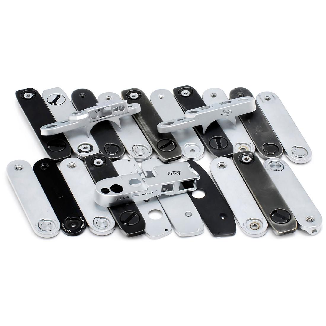 Leitz Top and Base-Plates: Leitz Top and Base-Plates Leitz, Wetzlar and Canada. 1) 3 top-plates: M4-P, IIIg and Ig, chrome. – And: 2) 20 base-plates (for screw-mount Leicas, Leica M and reflex), chrome and black. Deckkappen u