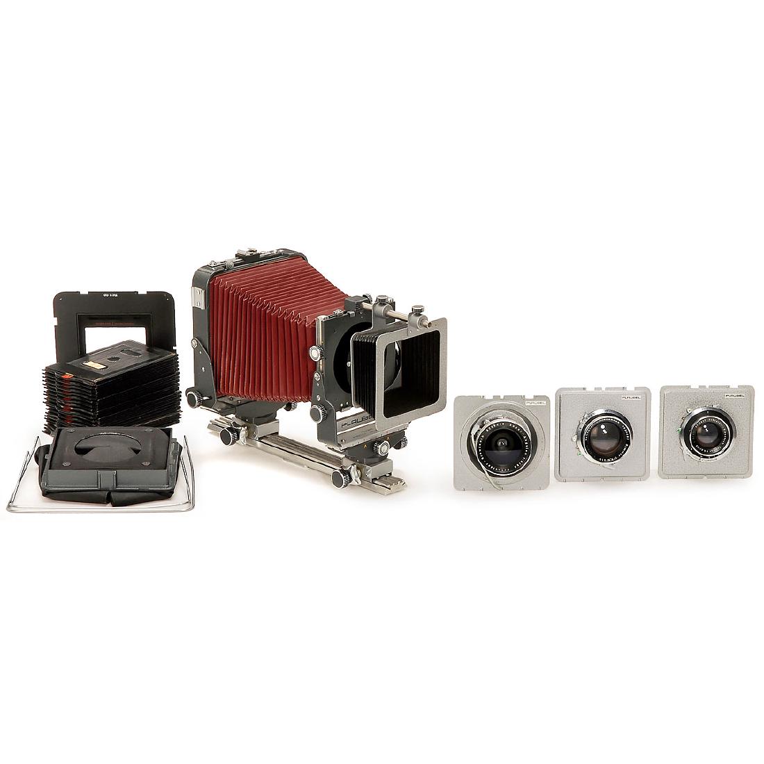 Plaubel Peco Junior PN1/01 Outfit: Plaubel Peco Junior PN1/01 Outfit Plaubel, Frankfurt. Studio camera for plates and rollfilm (6 x 9 cm to 10 x 15 cm), dark-red bellows, 9x12cm focusing screen back, 3 lenses: a) Super-Angulon 8/90 mm 