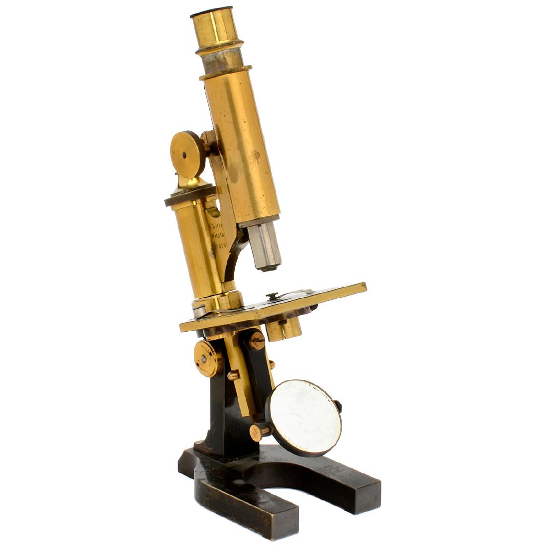 Leitz Brass Microscope, 1884: Leitz Brass Microscope, 1884 Ernst Leitz, Wetzlar. Serial no. 6292, original lacquered and darkened brass, double mirror, coarse and fine adjustment, 1 objective, 1 ocular, height 11 in. Messingmikros