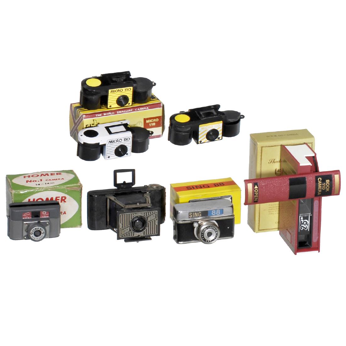 7 Subminiature Cameras: 7 Subminiature Cameras 1) Houghton's Ltd., London. Ensign Midget Model 22, c. 1935. Strut construction, size 3,5 x 4,5 cm, shutter I. + T. - 2) Webster Industries, China. Webster's Dictionary Book 110