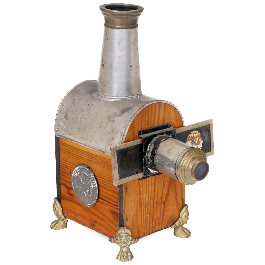 Jung Amerika Magic Lantern, c. 1890: "Jung Amerika" Magic Lantern, c. 1890 German, unknown manufacturer, for export to the USA. 12 in. high. - Literature: Hrabalek, no. 152, p. 125. -Original label doubling as taper. For slides of 2