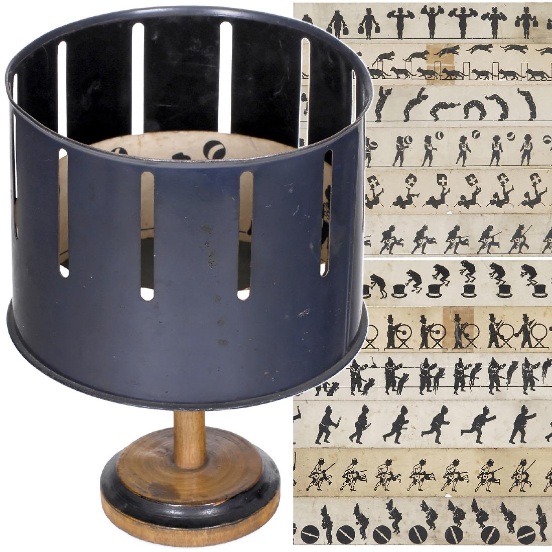 Miniature Zoetrope by Bing, c. 1900: Miniature Zoetrope by Bing, c. 1900 Gebr. Bing, Nuremberg. Tin drum and wooden base, drum size Ø 5 in., height with stand 7 in. with 6 double-sided strips (length 16 ½ in., height 1 ¾ i