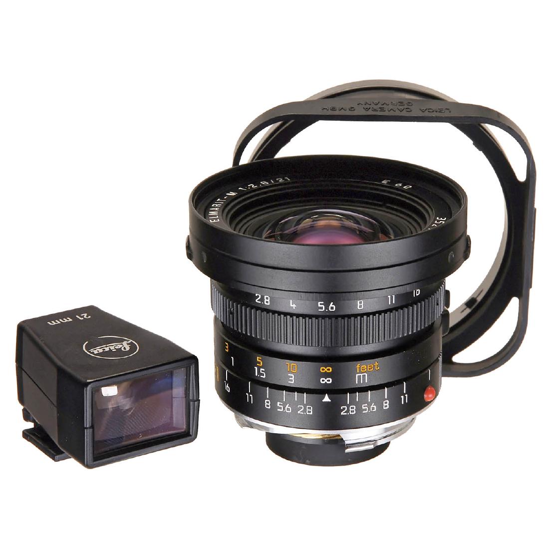 Leica Elmarit-M 2,8/21 mm, 1990: Leica Elmarit-M 2,8/21 mm, 1990 Leitz, Canada. No. 3524923 (E60), black. With lens hood, 2 caps, viewfinder 21 mm with case. Leica Elmarit-M 2,8/21 mm, 1990 Leitz, Canada. Nr. 3524923 (E60), schwarz. 