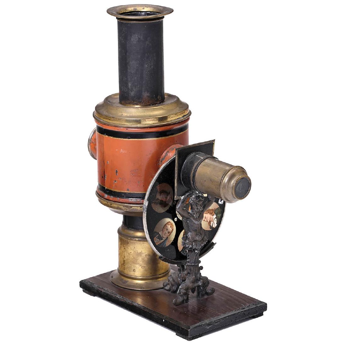 Magic Lantern by J. Schoenner, c. 1880: Magic Lantern by J. Schoenner, c. 1880 Jean Schoenner, Nürnberg. Height 11 ¾ in., red-black body for circular slides Ø 4 1/3 in., barrel-shaped body on original burner, wood base, with one disc. La