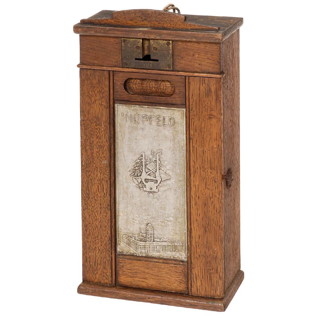 Hupfeld Coin Box, c. 1925: Hupfeld Coin Box, c. 1925 For electric pianos or orchestrions, walnut case, front with embossed tin plaque showing the Hupfeld factory building in Leipzig, complete with mechanism and mercury switch. 