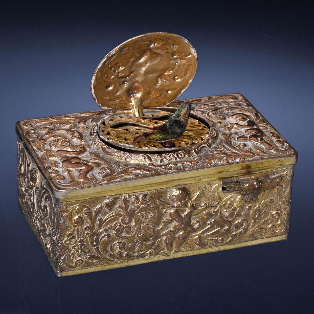 Singing Bird Box Automaton by Karl Griesbaum, c. 1930: Singing Bird Box Automaton by Karl Griesbaum, c. 1930 Model 5, with going-barrel movement, bellows and whistle, bird with iridescent plumage, moving beak, wings and perch, in pressed gilt-finish case