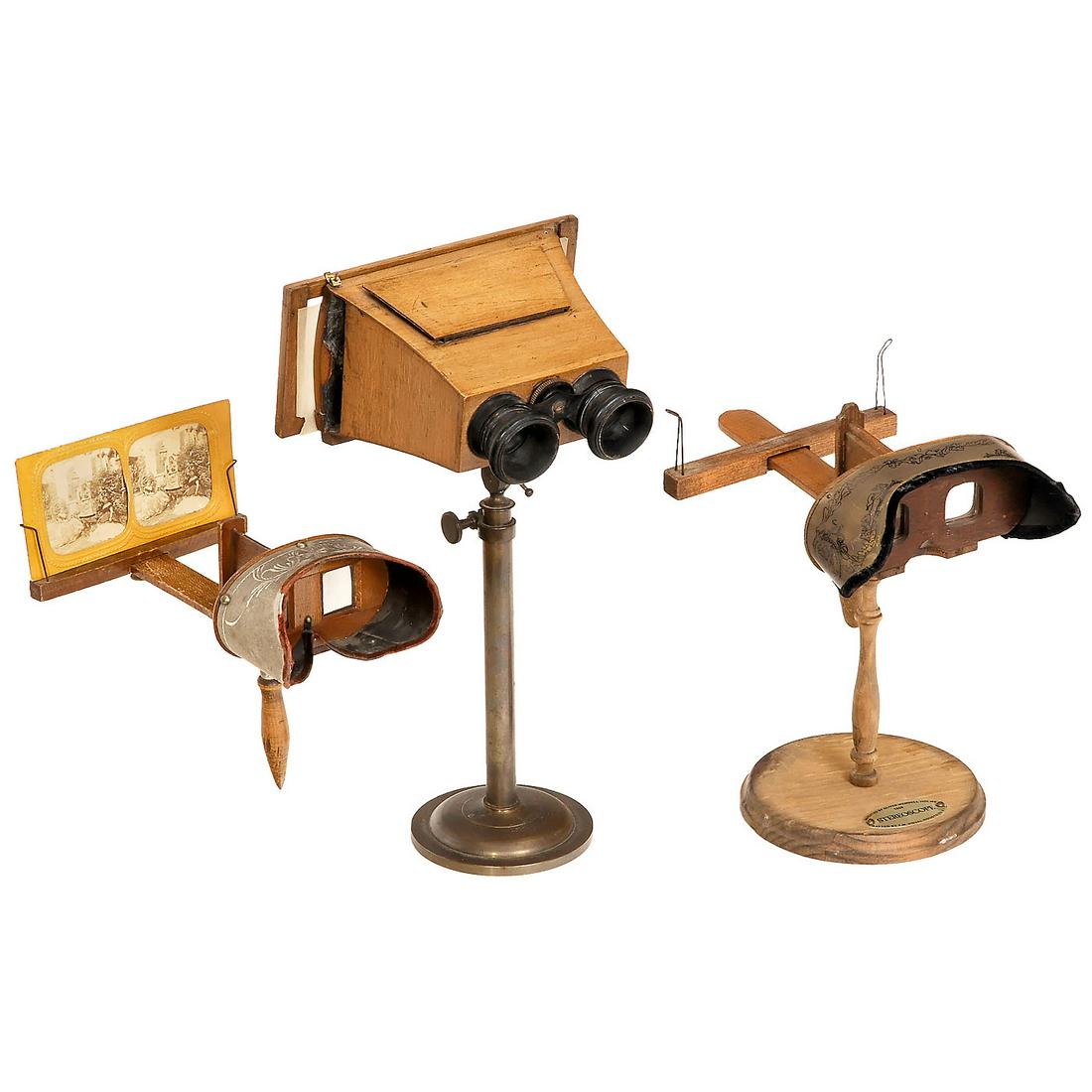 3 Stereo Viewers: 3 Stereo Viewers 1-2) 2 Holmes-pattern stereo viewers, for stereo cards of 9 x 18 cm, both with metal masks, one with stand (not original). - And: 3) Brewster-pattern stereo viewer for cards and slide