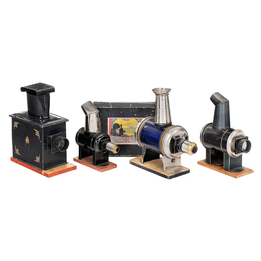 4 Magic Lanterns, c. 1880-1900: 4 Magic Lanterns, c. 1880-1900 1) Jean Schoenner, Nuremberg. Blue vertical metal body, with gilt ornamental rings, for slides with height of 1 ¾ in. (4,5 cm), lens and chimney original, on wood board