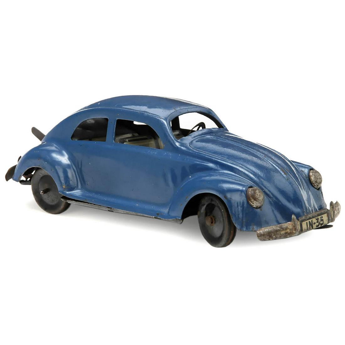 KdF Beetle by Johann Neuhierl, c. 1938: KdF Beetle by Johann Neuhierl, c. 1938 JNF - Johann Neuhierl, Fürth, Germany. VW "Pretzel" Beetle, license no. IN-35, tin, spring-driven (working), steerable front wheels, length 6 9/10 in., very rar