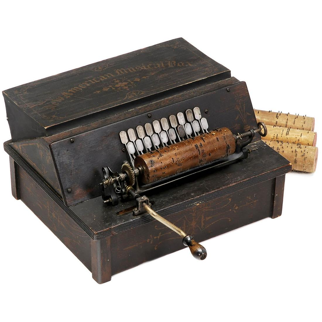 "New American Musical Box", 1887: "New American Musical Box", 1887 A variant of the Gem Roller Organ, hand-cranked reed organ, manufactured by "Autophon Company", gilt-ornamented wood case (14 1/5 x 12 ½ x 7 4/5 in.), metal-pin-stud