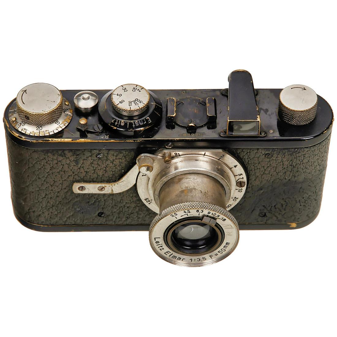 Leica Ia, c. 1928: Leica Ia, c. 1928 Leitz, Wetzlar. No. 8997, with Elmar 3,5/50 mm, mushroom-shaped shutter release, original finish partly intact, uneven wear to vulcanite, some splits, one lens mount screw replaced. 