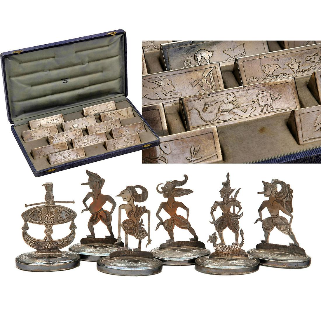 Art-Deco Knife-Rest Set and 6 Menu Card Holders, c.: Art-Deco Knife-Rest Set and 6 Menu Card Holders, c. 1930 1) Complete set of 12 French Art-Deco silver-plated knife rests by Stéphane Prudhomme in their original case, each depicting a stylized scene