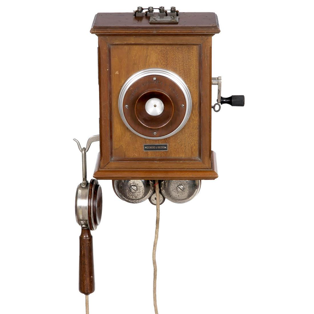 Wall Telephone by Siemens & Halske, 1893 onwards: Wall Telephone by Siemens & Halske, 1893 onwards Siemens & Halske, Berlin. Polished walnut case, carbon granulate transmitter, spoon-shaped earphone, 3-part crank inductor, double bell, with lock and 