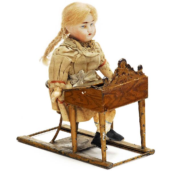Pupil at Tin School Desk, c. 1910: Pupil at Tin School Desk, c. 1910 Table and chair made of hand-colored tin, length: 5 in. Small bisque head doll, marked "Montreuil, France, D.L., 3", composition material arms and legs, original dres