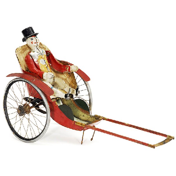 Rickshaw with Mechanical Clown: Rickshaw with Mechanical Clown 1) Clown figure, hand-painted tin, unmarked, clockwork, winding by turning the arms, height: 7 in., works well! - And: 2) Elegant tin rickshaw, upholstered seat, length: