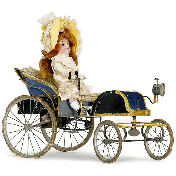 Horseless Carriage with Doll ("Vichy"), c. 1895: Horseless Carriage with Doll ("Vichy"), c. 1895 Early French tin toy car, hand-japanned tin, spoke wheels with rubber tyres, steerable front axle, clockwork motor drive (working), length 10 1/5 in., w