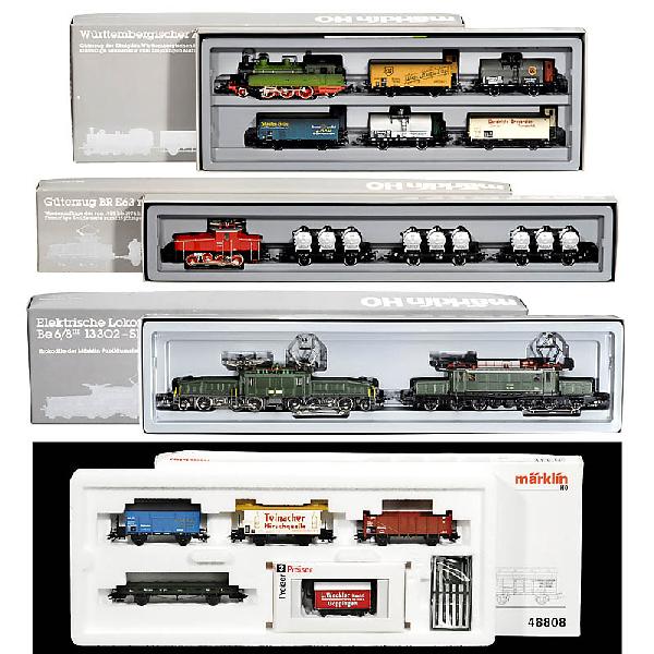 4 Train Sets "Märklin" (Gauge H0): 4 Train Sets "Märklin" (Gauge H0) 1) 2 Märklin "crocodiles" of the anniversary tour from 1984, no. 3300. - 2) Wuerttemberger train no. 2857. - 3) Freight train with 3 wagons no. 2874. - And: 4) Frei