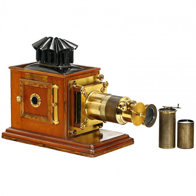 Magic Lantern W. C. Hughes, c. 1900: Magic Lantern W. C. Hughes, c. 1900 Mahogany magic lantern, approx. 17 in. high. In good condition. With 3 optics and original electrical equipment. Original metal box. - Excellent collector's item. "