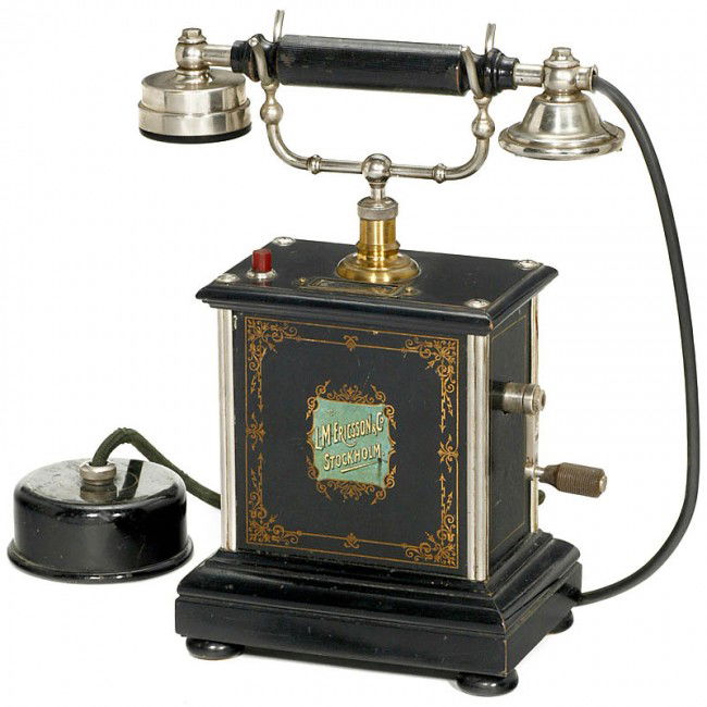 Desk Telephone "L. M. Ericsson", from 1902: Desk Telephone "L. M. Ericsson", from 1902 Decorated tin case, wooden base, double bell, magneto generator, wire renewed, good original condition! Tischtelephon "L. M. Ericsson", ab 1902 Verziertes Bl