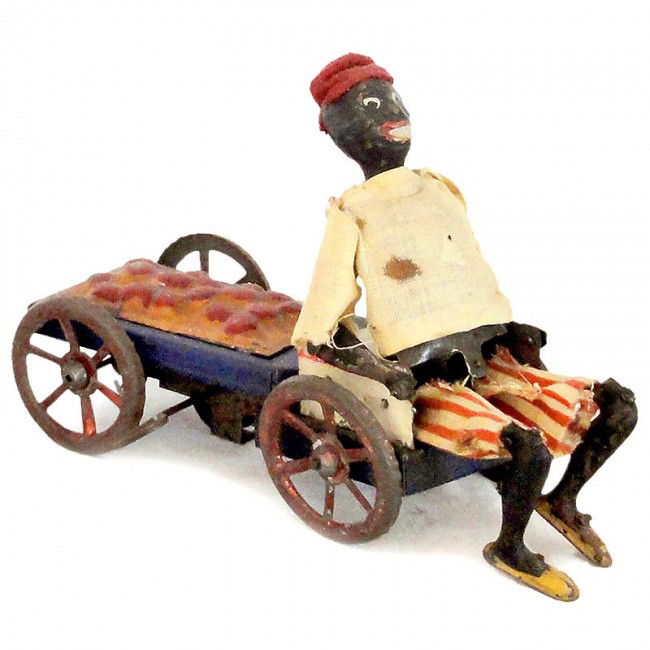 Fernand Martin "Orange Cart" (No. 218), 1910: Fernand Martin "Orange Cart" (No. 218), 1910 "L'Autopatte", rare French toy figure, hand-japanned tin, original clothes, spring action (working), length 7 1/2 in. - The black boy seated on the cart, t