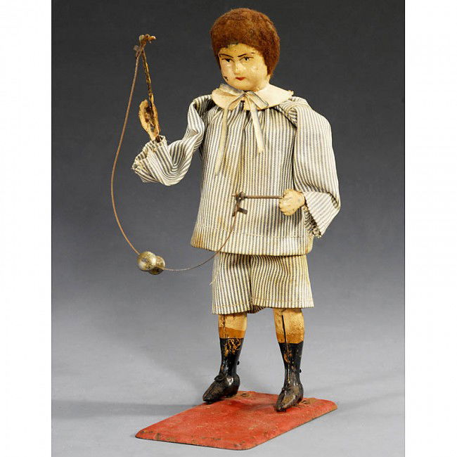 Fernand Martin: "Boy with Diabolo" (No. 208), 1907: Fernand Martin: "Boy with Diabolo" (No. 208), 1907 "La Joueuse de Diabolo", rare French toy figure, hand-japanned tin, original clothes, spring action (working). When wound he shifts his hands up and