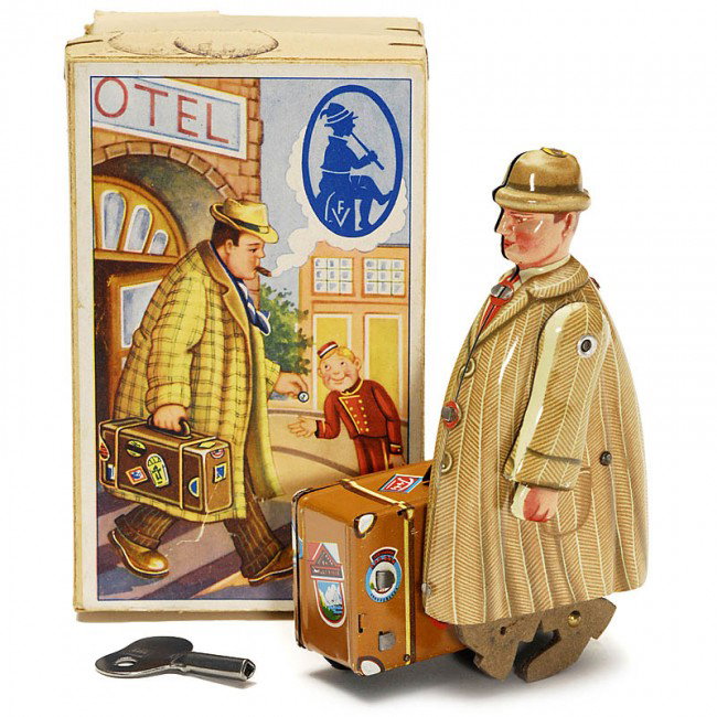 Walking Man with Suitcase by "Fritz Voit", c. 1955: Walking Man with Suitcase by "Fritz Voit", c. 1955 Lithographed tin, rotating legs (cardboard), clockwork, nearly new condition with box. - A rare and funny tin toy, made by a small German manufacture