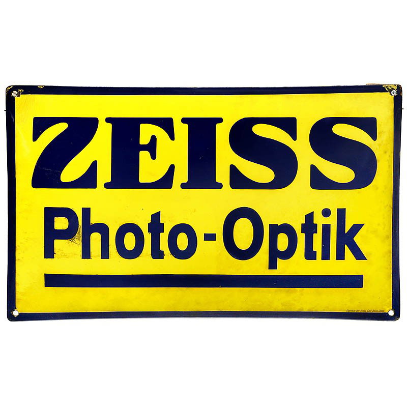 Enamel Advertising Sign "Zeiss Photo-Optik": Enamel Advertising Sign "Zeiss Photo-Optik" Arched, size 19 5/8 x 11 3/4 in., with inscription: Property of the Carl Zeiss company in Jena (in German language). Emaille-Werbeschild "Zeiss Photo-Optik"