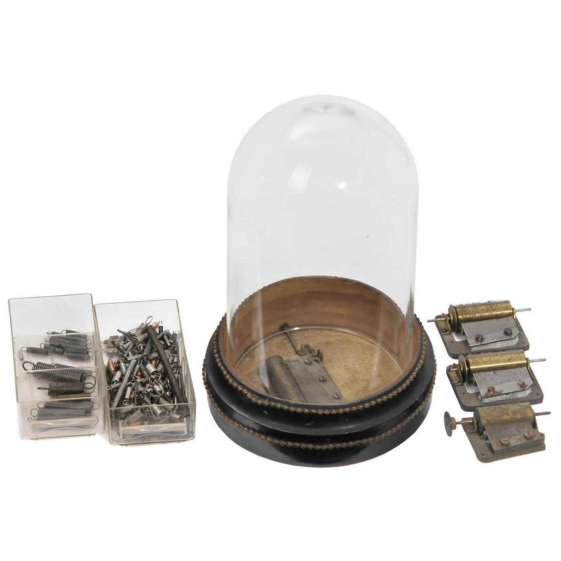 Spare Parts for Automata Restoration: Spare Parts for Automata Restoration 3 springless musical movements (for clocks or automata); an ebonized base with a musical movement (missing a tooth) and Perspex dome; group of mixed return springs