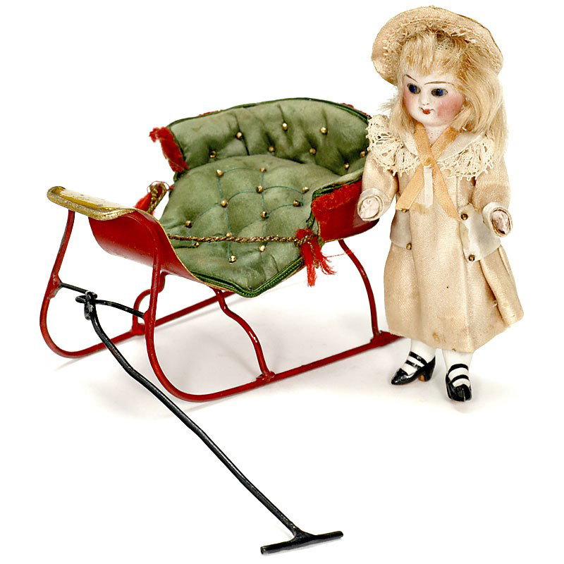 Sled with Doll by "Rock & Graner", c. 1880: Sled with Doll by "Rock & Graner", c. 1880 Hand-japanned tin sled, upholstered, length with handle 8 1/4 in., bisque doll in original clothes, height 4 in. - Very fine toy! Schlitten mit Puppe "Rock &