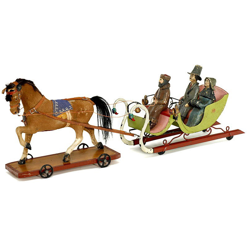 Horse-Drawn Sleigh by "Rock & Graner", c. 1880: Horse-Drawn Sleigh by "Rock & Graner", c. 1880 Hand-painted tin (original finish!), on disc wheels, with 2 lamps and bell, 3 composition figures, length of the sleigh: 11 3/4 in. With draught horse on