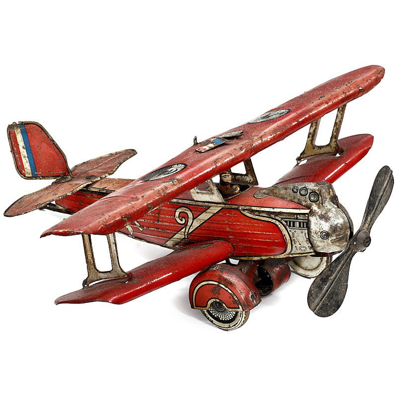 Biplane "Günthermann", c. 1931: Biplane "Günthermann", c. 1931 Manufactured by: "Siegfried Günthermann, Nuremberg", lithographed tin, clockwork drive on wheels and propeller (working), length: 13 in. In this Breguet type plane, Co
