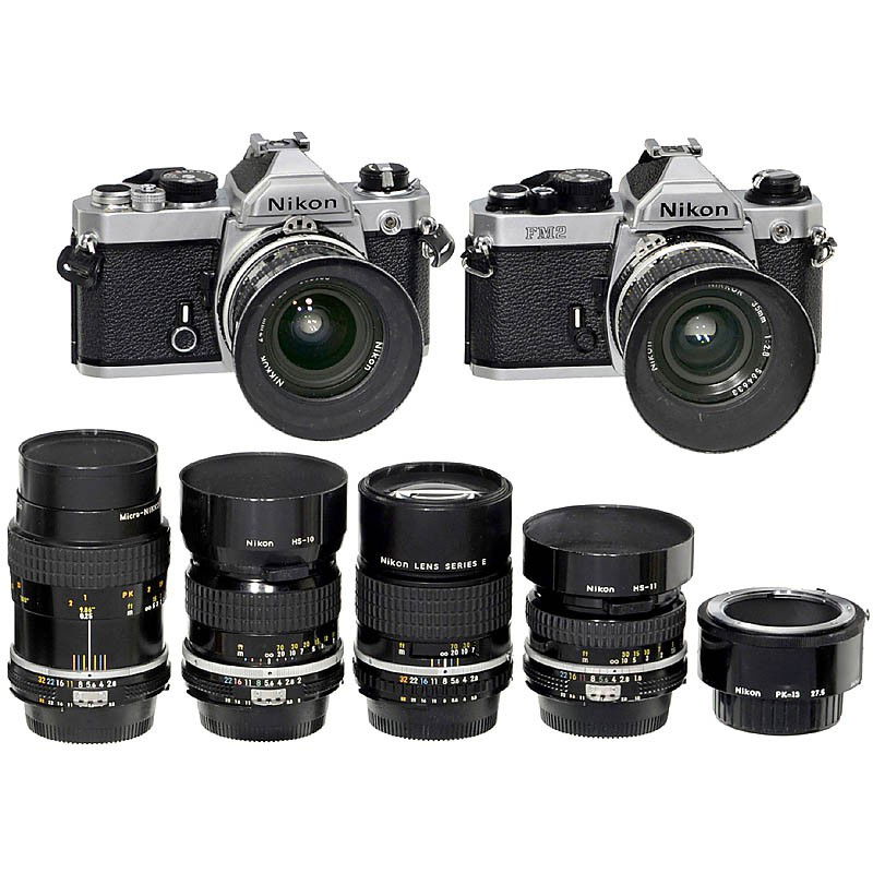 Nikon FM, FM2 and 6 Lenses: Nikon FM, FM2 and 6 Lenses Nikon, Japan. 1) Nikon FM, chrome, no. 2428414, shutter working, light meter untested. (3/2) - 2) Nikon FM2, chrome, no. 7869208, light meter working. (2-/2). - 3) Nikkor 2,
