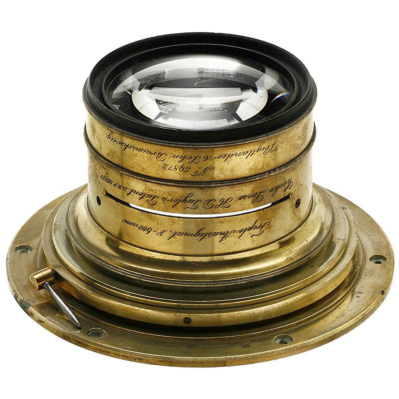 Triple Anastigmat F = 600 mm, c. 1899: Triple Anastigmat F = 600 mm, c. 1899 Voigtländer, Braunschweig. Produced by H.D. Taylor's in London. "Cooke Lens", anastigmatic universal lens, brass, no. 59872, 600 mm focal length, front element �