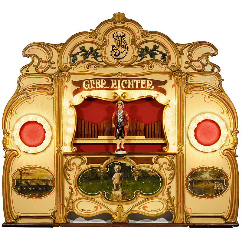 Very Decorative Front of a Fairground Organ by "Ge: Very Decorative Front of a Fairground Organ by "Gebrüder Richter", c. 1900 Wood, with carved ornaments, 4 parts, electric lighting, organ figure later, size 103 x 12 x 93 in. Äußerst dekorative Fro