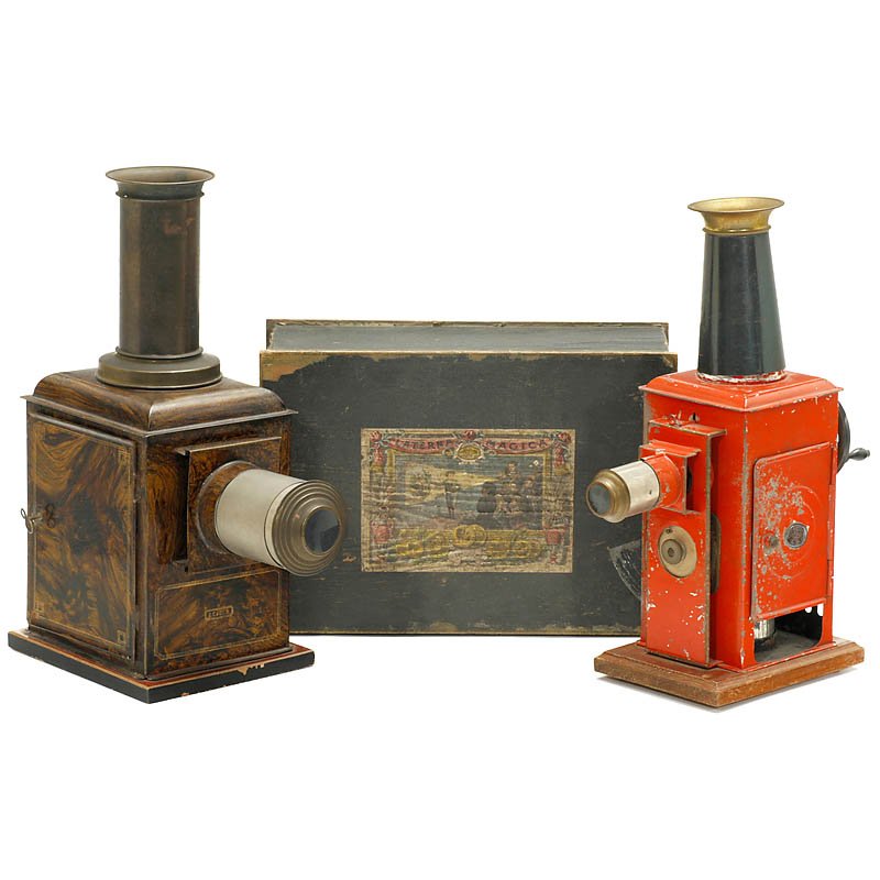 2 Rare Magic Lanterns, c. 1900: 2 Rare Magic Lanterns, c. 1900 1) German metal lantern by Georges Carette, with wood imitation paint. Without burner, 14,7 in. high. For 3,5 in. slides. - 2) Unknown Ernst Plank lantern. With crank on