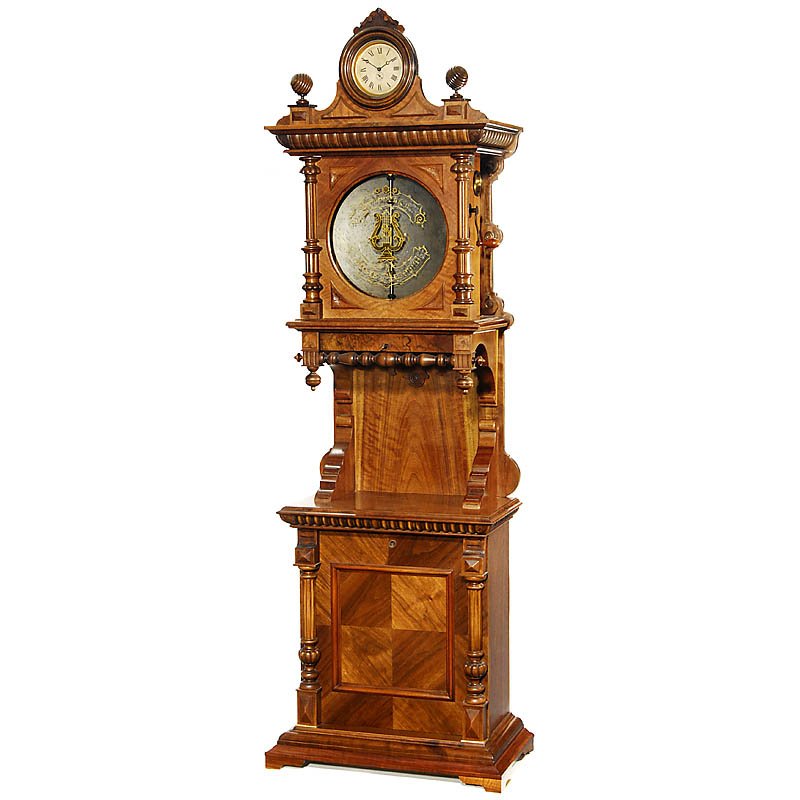 "Symphonion Meteor" Disc Musical Box, c. 1900: "Symphonion Meteor" Disc Musical Box, c. 1900 Model no. 39, with old base cabinet (added) and clock on the top, coin-operated, for 13 1/2 in. discs, 100 teeth in duplex combs (complete), size 28 x 15