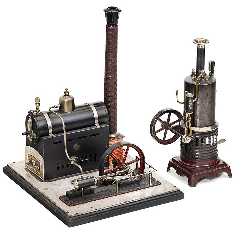 2 Steam Engines "Bing", c. 1910: 2 Steam Engines "Bing", c. 1910 1) "No. 8551/1", vertical steam engine "Royal", flywheel Ø 2 3/4 in., height 11 in. - And: 2) "No. 130/235", horizontal steam engine with vaporizing burner, flywheel �